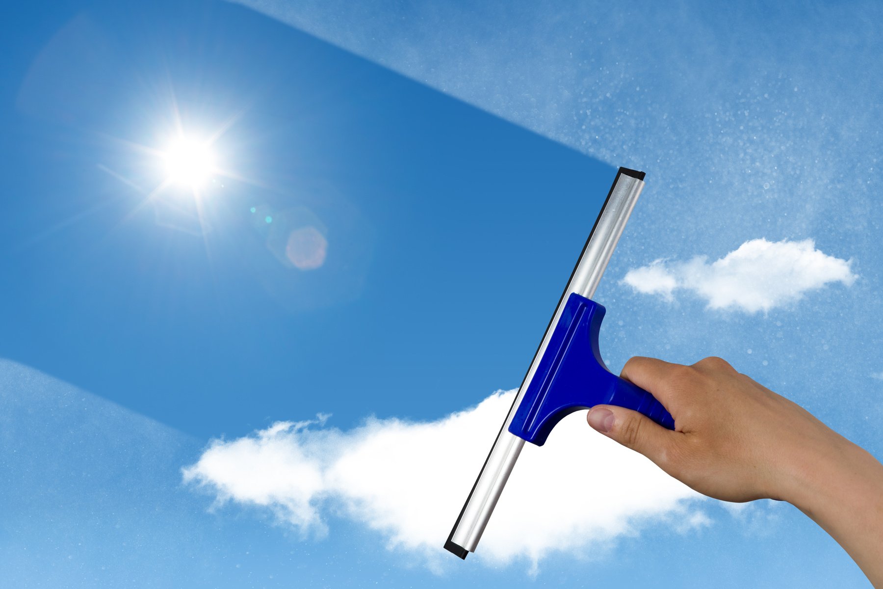 squeegee cleaning a dirty window